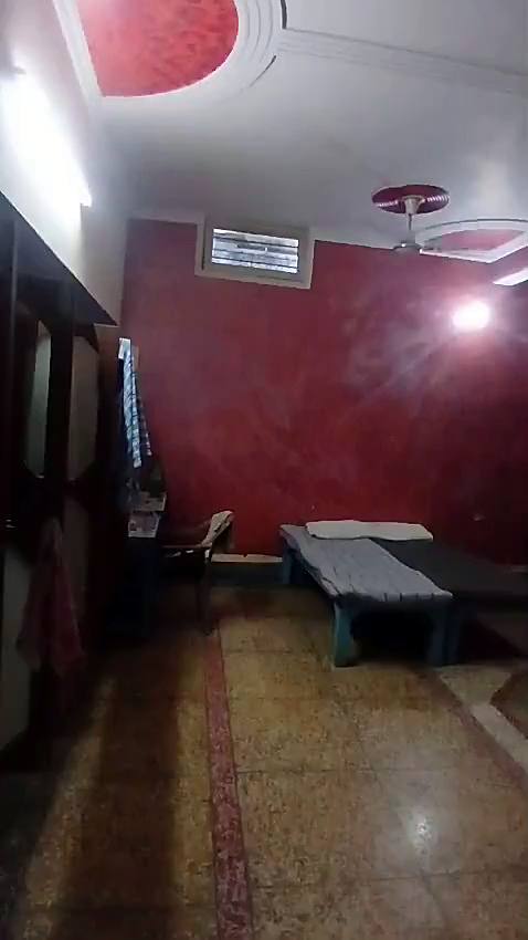 A large room with beds and ceiling fans